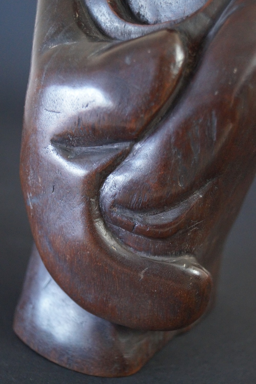 Bodhidharma Daruma figure made of hardwood hand close-up