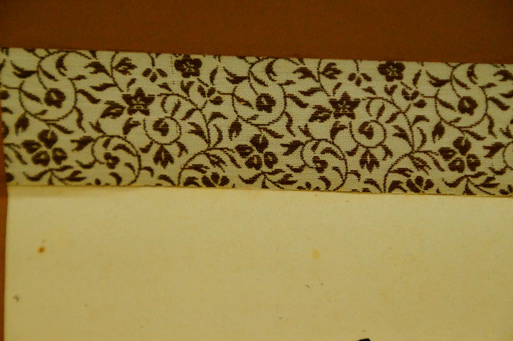 Close-up of the patterned brocade border of the hanging scroll