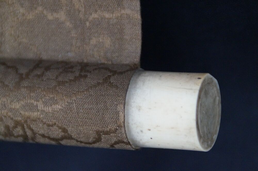 Detail view of the scroll end with ivory roller knob and brocade silk of the Kakemono Cranes in Flight over Bamboo