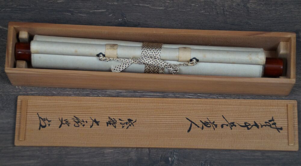 Opened storage box with inscription and rolled-up kakemono calligraphy no matters