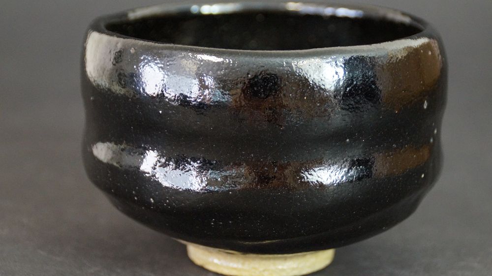 Additional side view of the chawan of Raku ware with black glaze