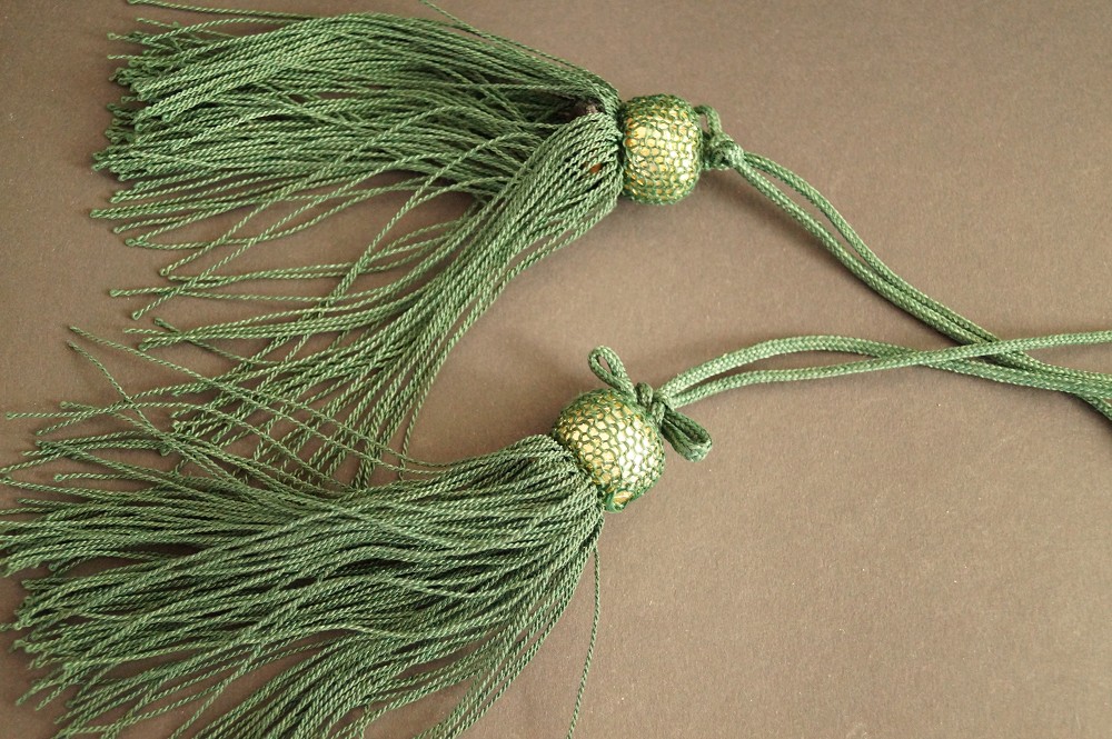 Two green silk tassels with gold-colored beads tassel close-up 2