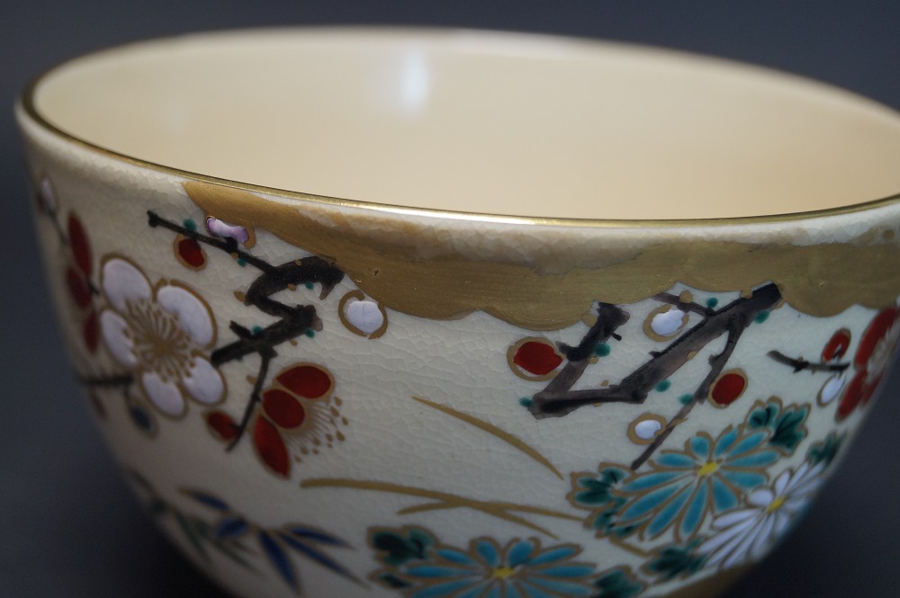 Tea bowl chawan by Kansai Tsuji gold rim with plum blossoms close-up