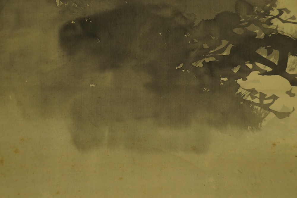 Close-up of the ink-washed rocks and pine silhouette in the background
