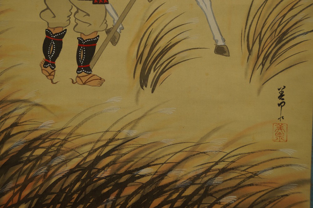 Close-up of the retainer's legs in the tall autumn grass