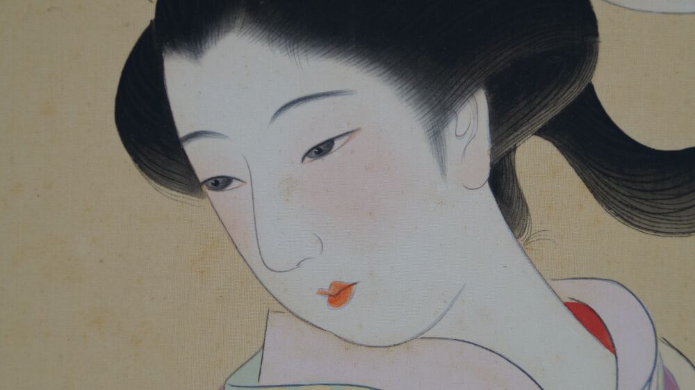 Close-up of the young woman's face in the Kakemono Young Woman in Front of Her Kimono Cabinet