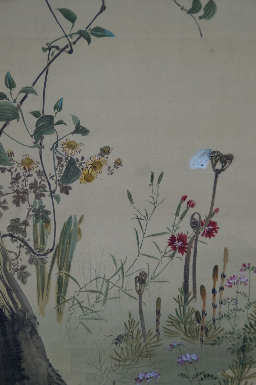 Detail view of butterfly, red carnations, and yellow chrysanthemums in the kakemono