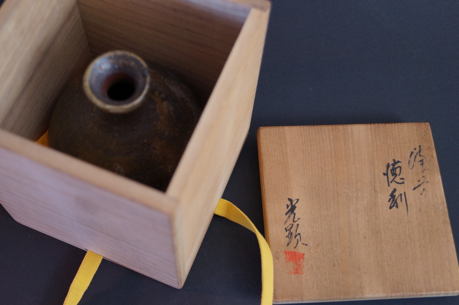 The sake bottle standing in the opened storage box