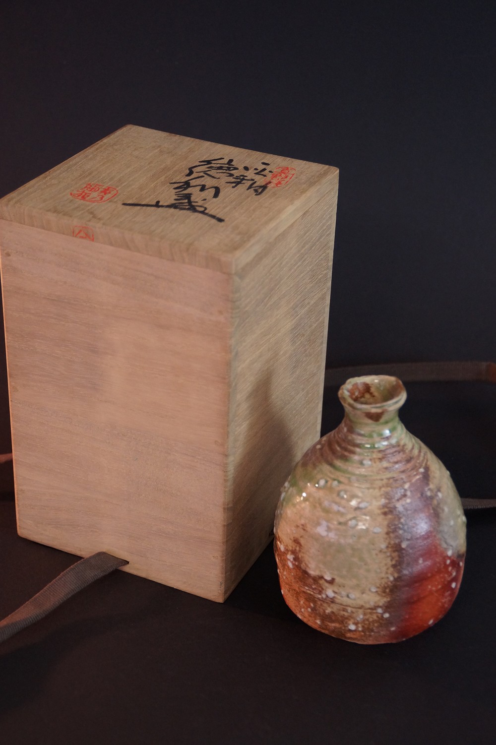 The Tokkuri in Front of the Opened Storage Box with Lid and Red Seal