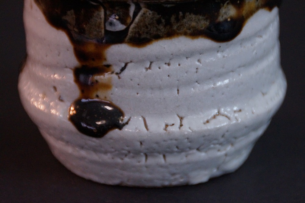 Close-up of the flared neck of the tokkuri with iridescent glaze