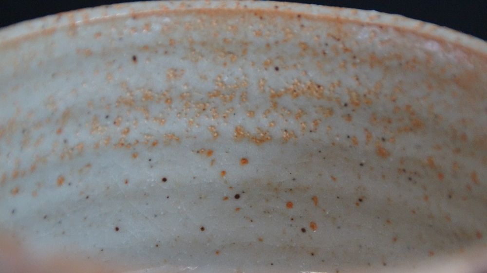 Close-up of the cream-white interior glaze of the chawan made of Shino ware