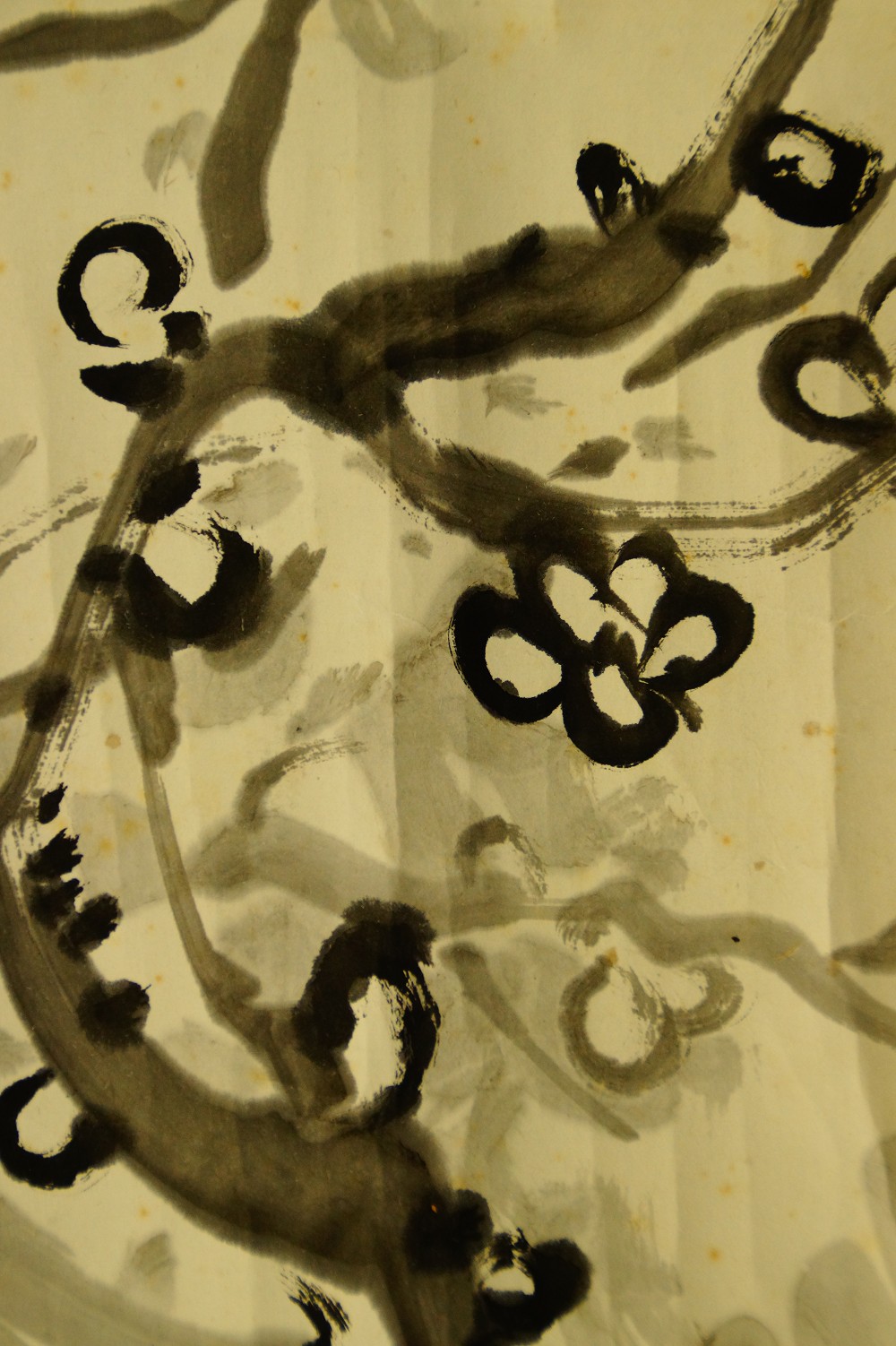 Close-up of the circularly dotted plum blossom buds in ink