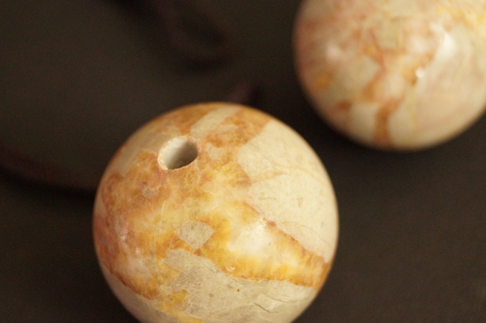 Two Orange-Veined Stone Spheres Side by Side Stone Close-Up 4
