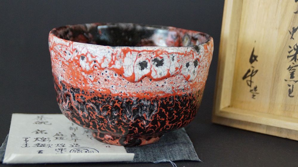 Close-up of the chawan tea bowl with handwritten certificate of authenticity and labeled storage box