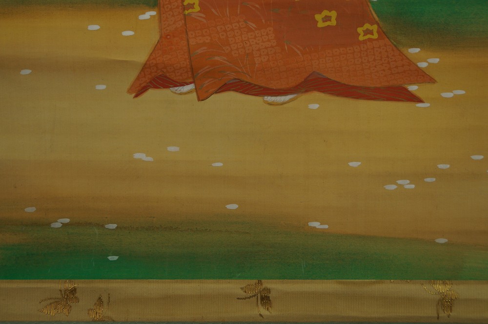 Close-up of the kimono hem with fallen sakura blossoms on the ground