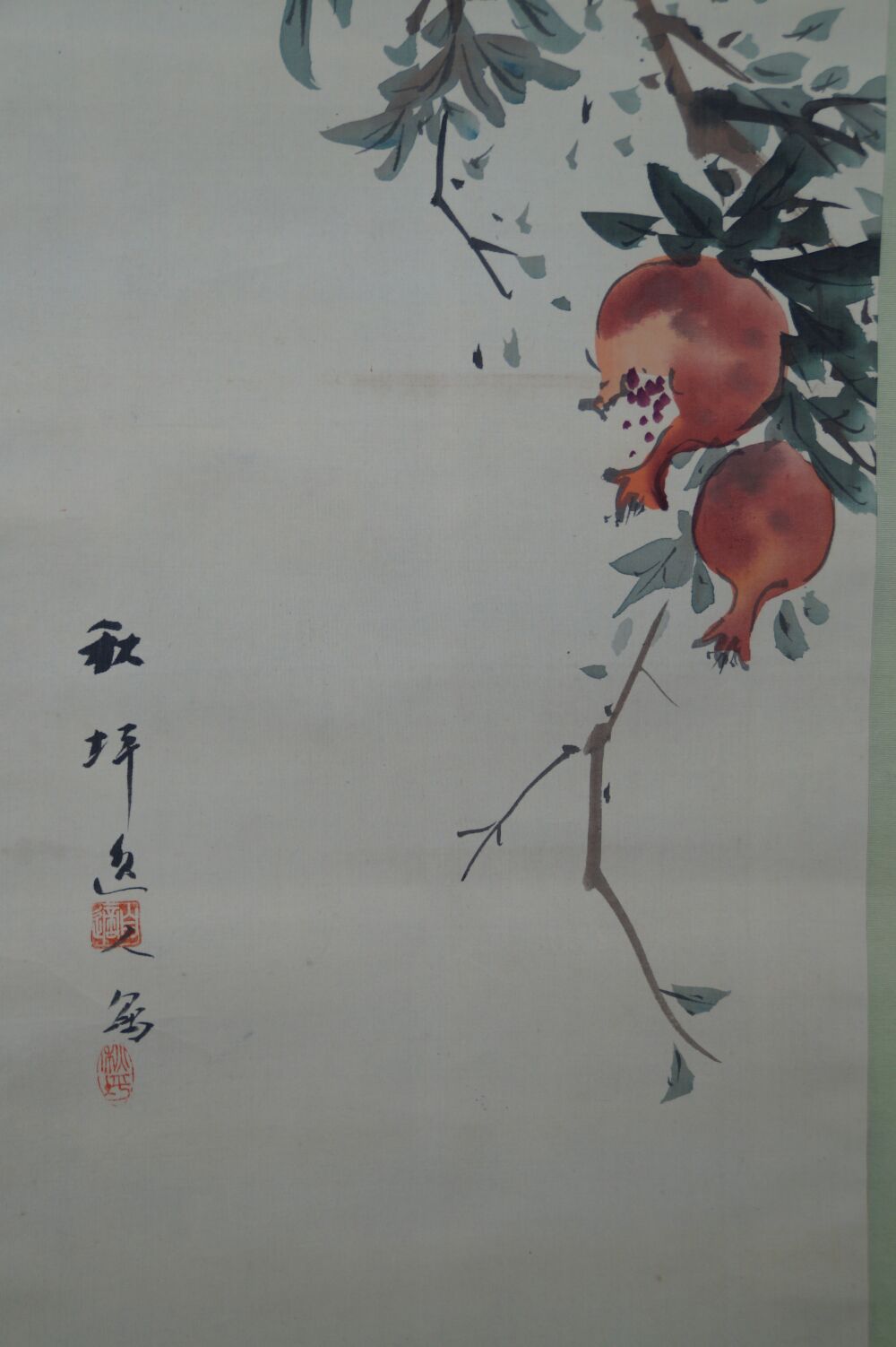Close-up of two ripe pomegranate fruits with artist's signature in the kakemono Pomegranate Branch and Starling