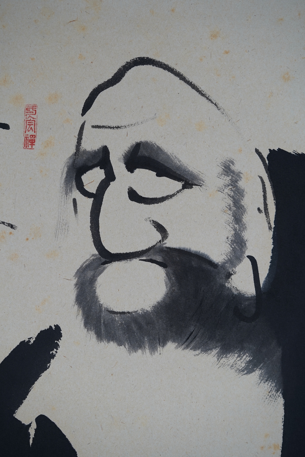 Further close-up of the Daruma face with expressive ink brushstroke