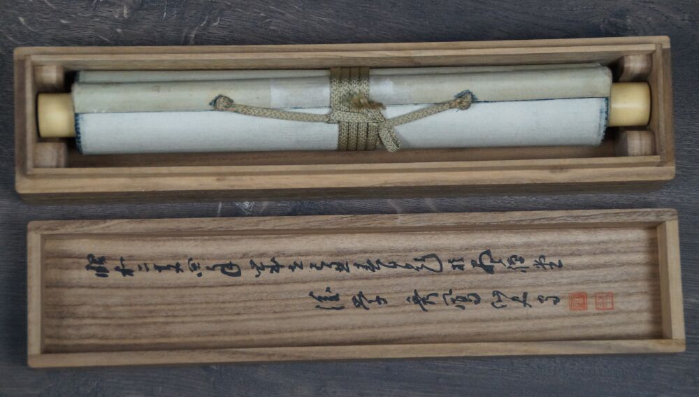 Opened storage box with the rolled-up hanging scroll Japanese Eggplant