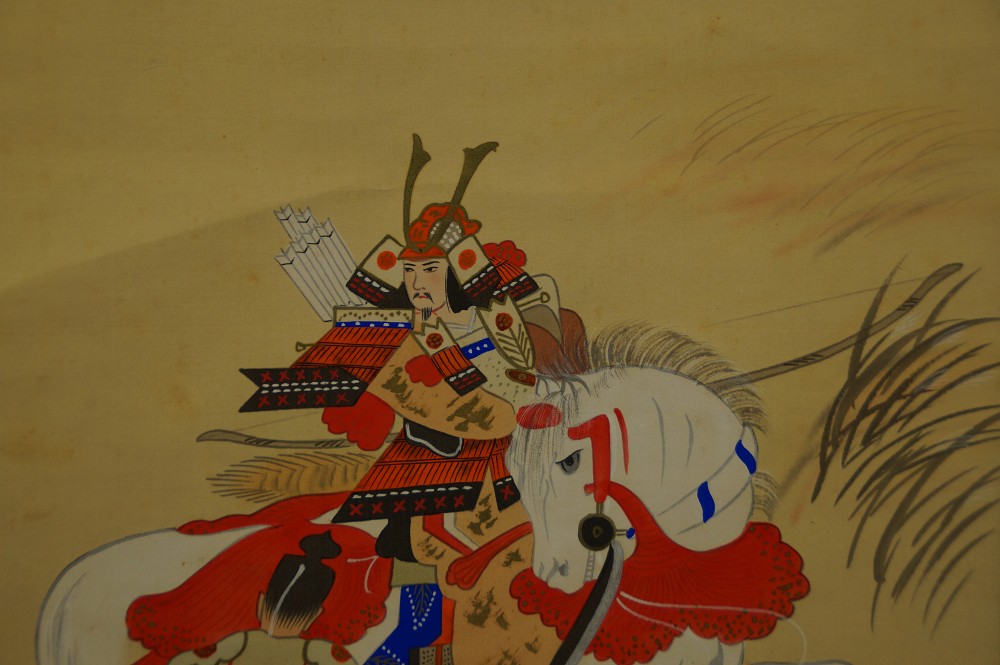 Close-up of the mounted samurai with helmet, feather ornament, and quiver
