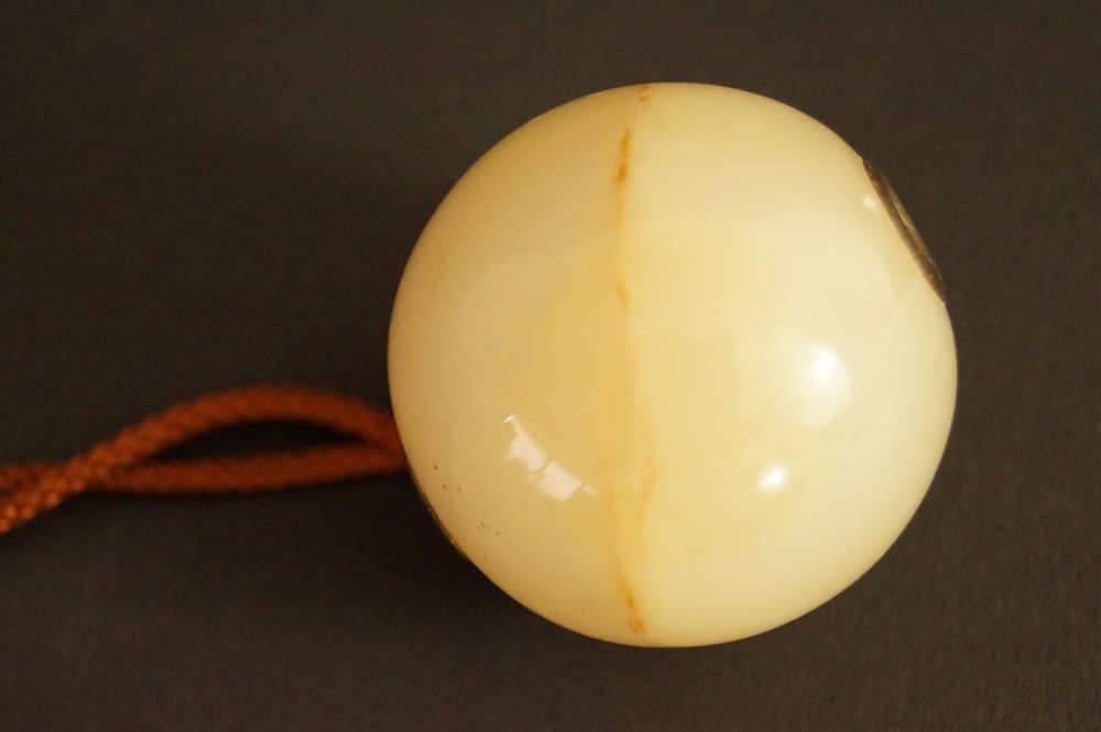 Natural stone sphere with light veining in close-up Stone Close-Up 3