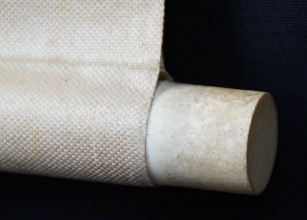 Detail view of the roller end with cream-colored silk and light wood knob of the Kakemono Spring at the Old Cherry Blossom