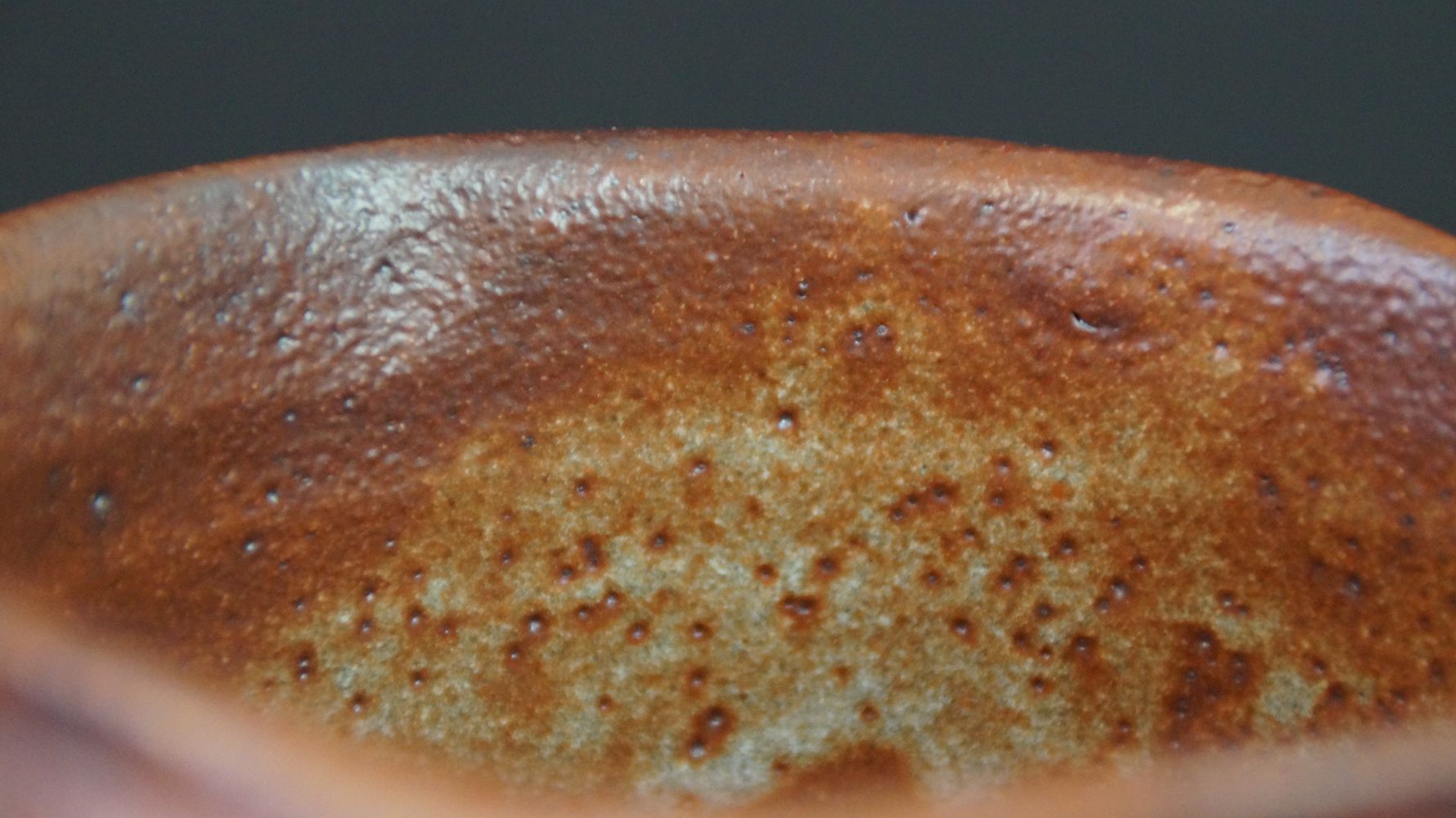 Close-up of the reddish-brown speckled interior glaze of the chawan tea bowl made of Shino ware