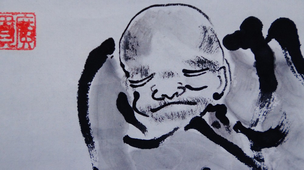 Extreme close-up of the face of the ink-painted Zen master with red seal