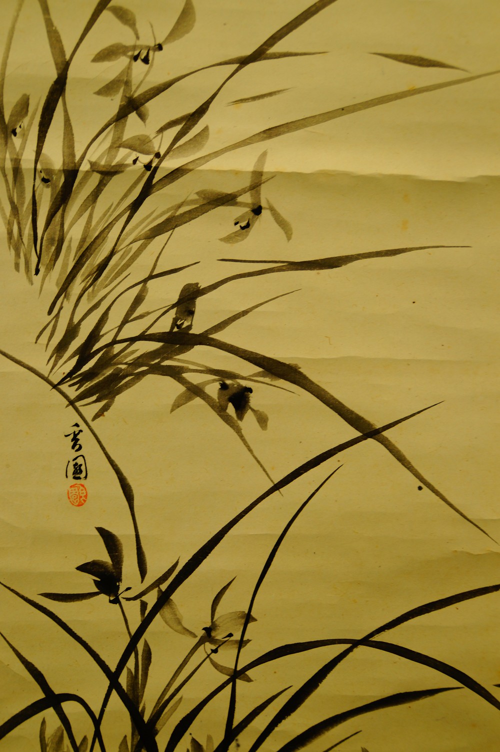 Close-up of the grasses with round artist's seal at the left edge of the image