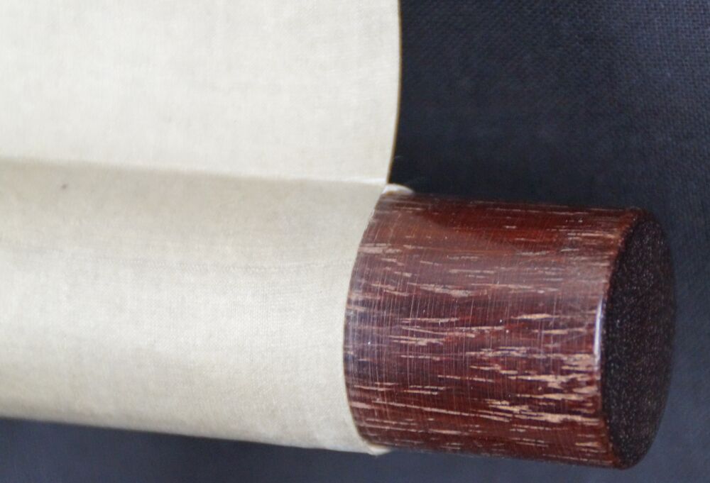 Detail View of the Scroll End with Dark Red Wooden Knob and Cream-Colored Silk of the Kakemono Mount Fuji in Cloud-Covered Heights