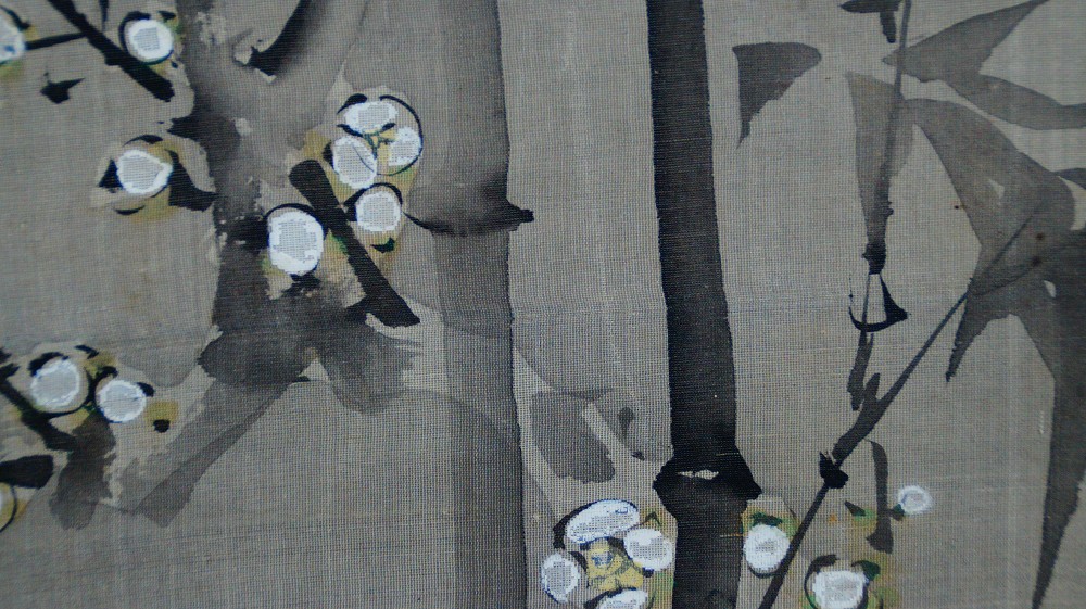 Close-up of the bamboo stalks and blooming plum branches