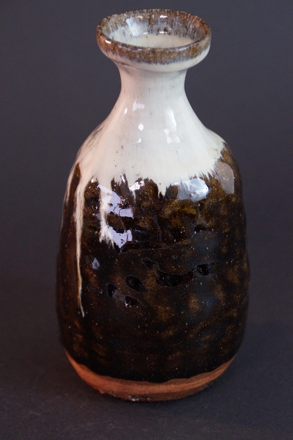 Further side view of the tokkuri with shimmering brown tones