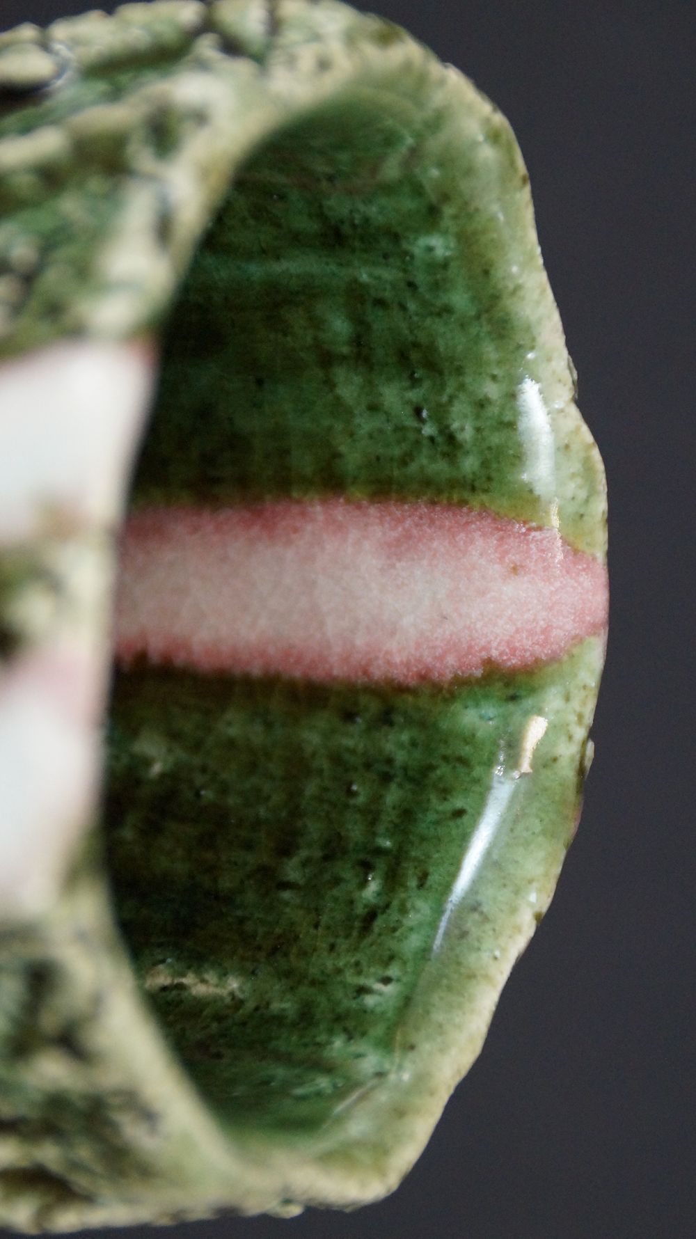 Close-up of the green interior glaze with a pink stripe of the yunomi tea bowl made of Oribe ware