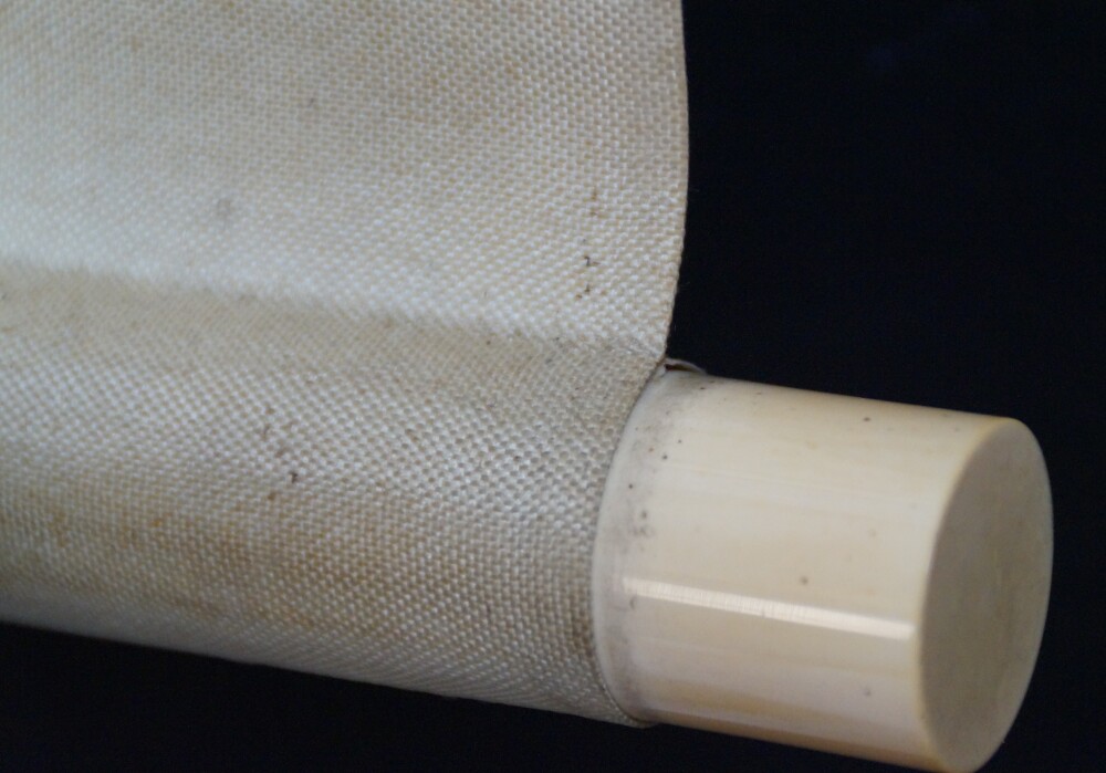 Close-up of the ivory-colored scroll end with cream-colored silk in the kakemono House in the Mist on a Mountain Slope by Hashimoto Gaho