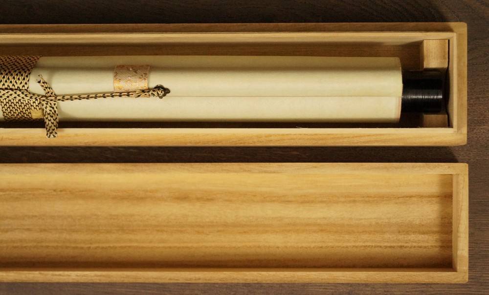 Rolled up hanging scroll in open wooden box before tying kakemono rolled up 1