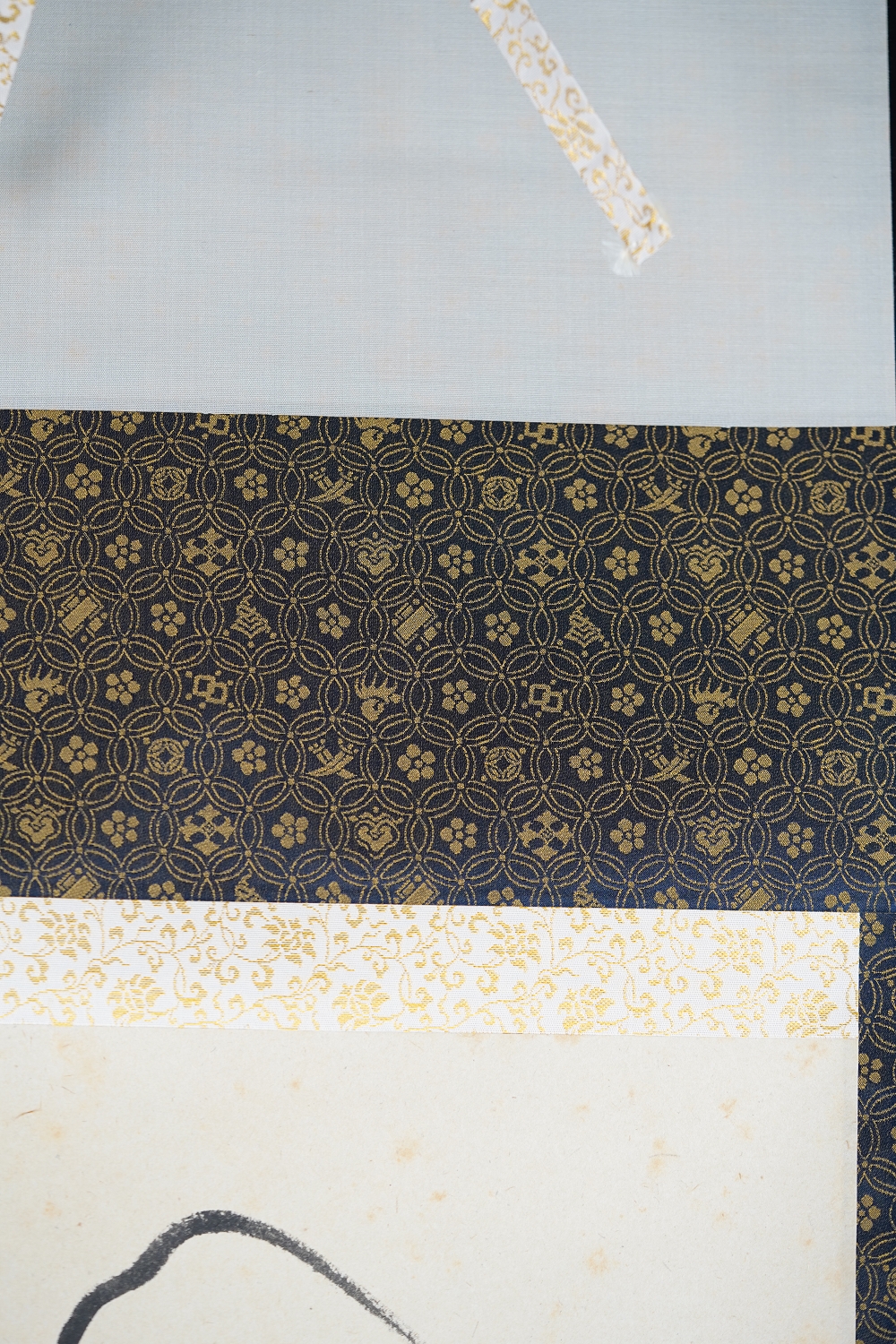Detail View of the Dark Blue Silk Mounting with Gold Pattern of the Kakemono Daruma in Ink