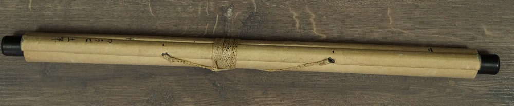 Rolled-up hanging scroll tied with cord with wooden jikusaki